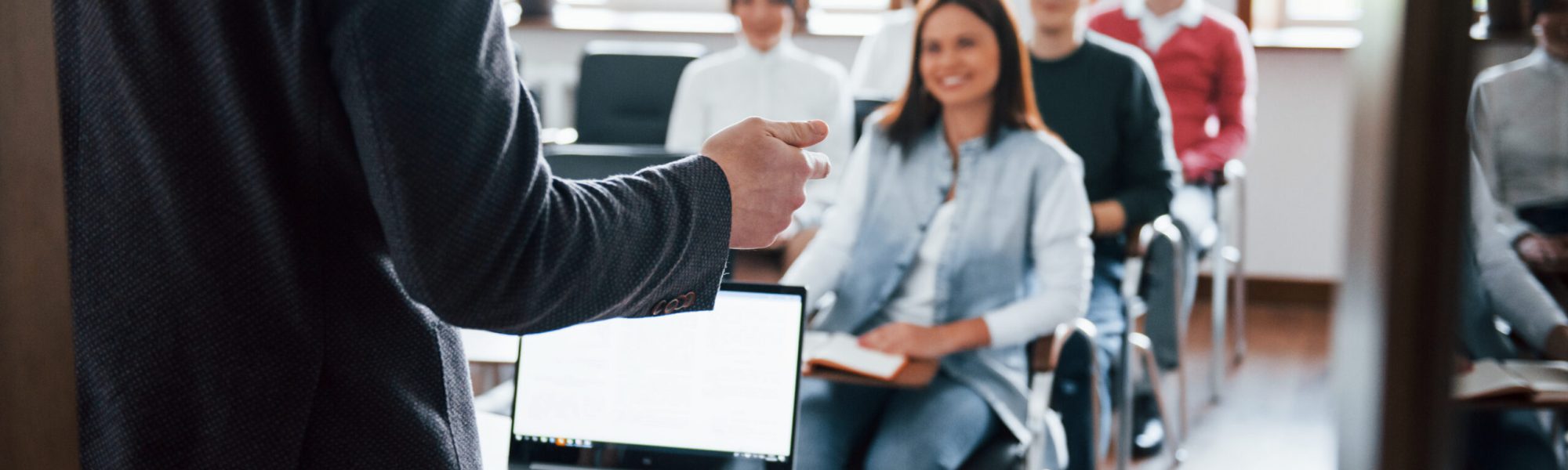 Cheerful mood. Group of people at business conference in modern classroom at daytime.